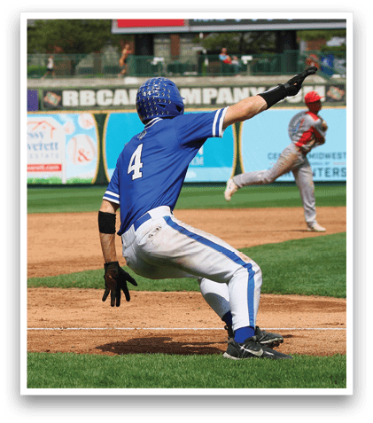 A baseball player in a blue and white uniform is sliding into a base. Description generated by AI