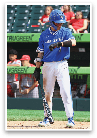 A baseball player wearing a blue shirt and white pants. Description generated by AI