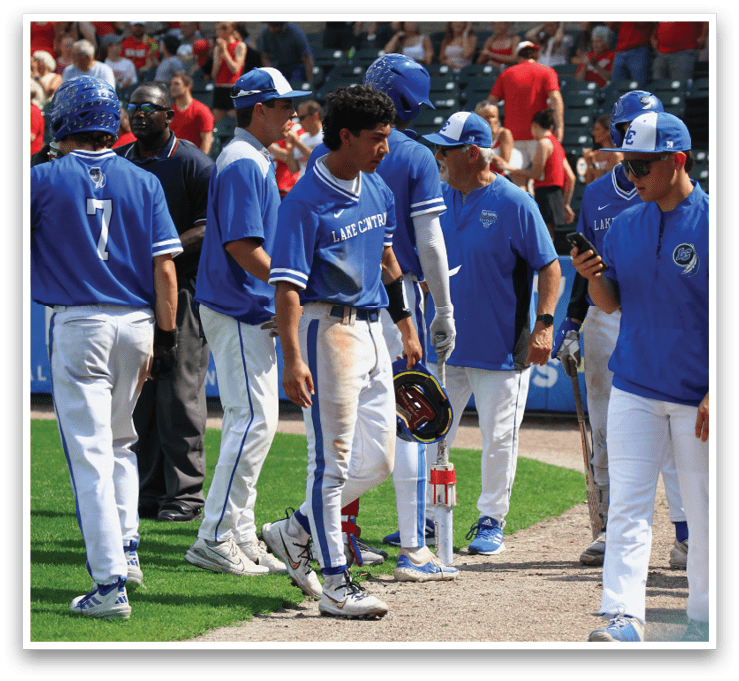 A group of baseball players wearing blue uniforms. Description generated by AI
