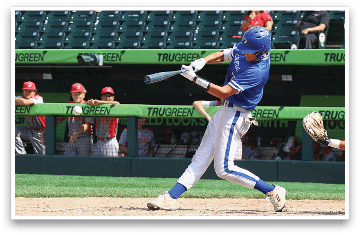 A baseball player in a blue and white uniform is swinging a bat. Description generated by AI