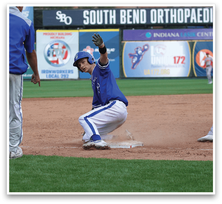 A baseball player sliding into a base. Description generated by AI