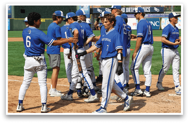 Baseball players wearing blue and white uniforms. Description generated by AI
