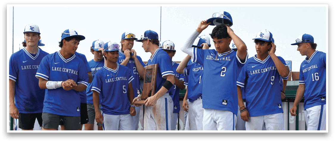 A group of baseball players wearing blue uniforms. Description generated by AI