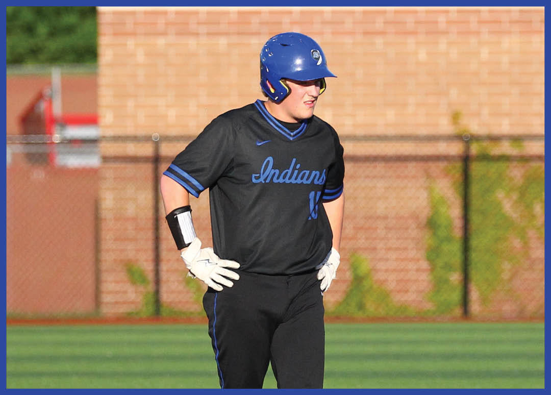 A baseball player wearing a blue helmet and black jersey. Description generated by AI