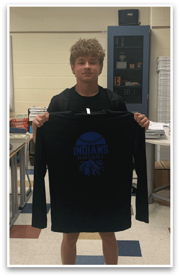 A boy wearing a black shirt with the word Indians on it. Description generated by AI