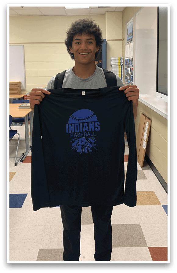 A man wearing a black shirt with the word Indians on it. Description generated by AI
