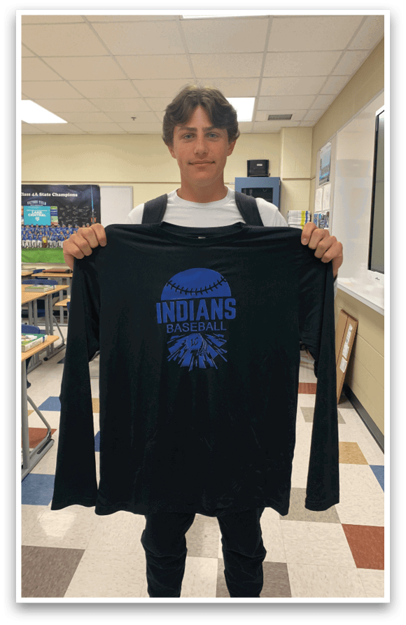 A man wearing a black shirt with the word Indians on it. Description generated by AI