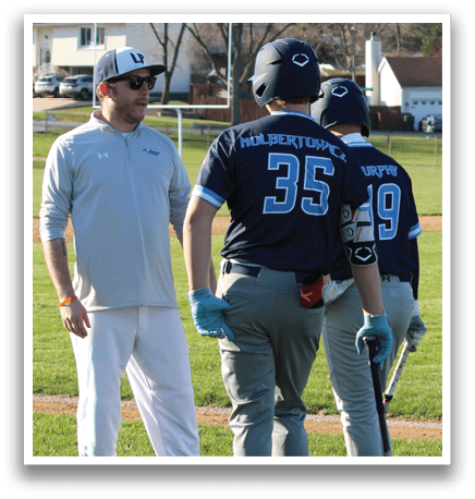 A baseball game is taking place with players on the field. A man in a blue shirt is holding a baseball bat, while another man in a white shirt is standing nearby. There are several other people on the field, some of whom are wearing baseball gloves. The scene is set on a grassy field, and a car can be seen in the background. AI generated content