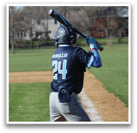 A baseball player in a blue shirt is holding a bat, ready to swing at a pitch. AI generated content