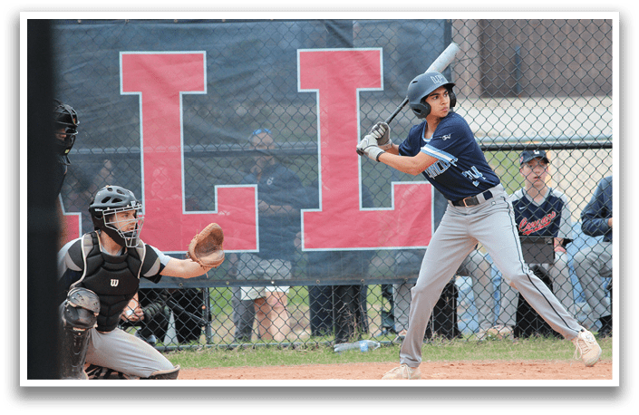 A baseball player in a blue shirt and grey pants is swinging a bat on a field. AI generated content
