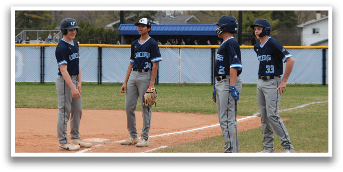 Baseball players on a field, some wearing blue and white uniforms, standing in the dirt. AI generated content