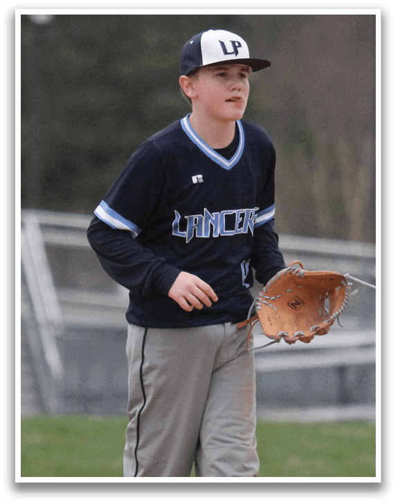 A boy wearing a baseball uniform is standing on a baseball field. AI generated content