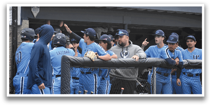 A group of baseball players wearing blue uniforms are gathered around a fence. AI generated content