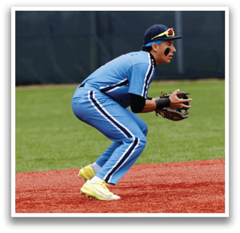 A baseball player in a blue uniform is crouching on the field, wearing a black glove and holding his catcher's mitt. AI generated content