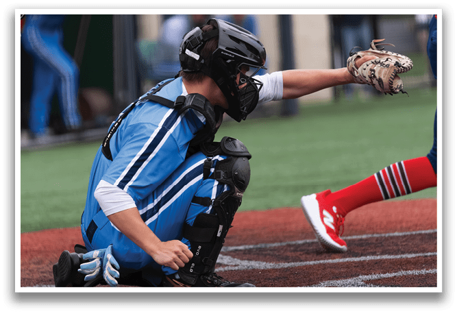 A baseball player in a blue uniform is kneeling on the ground, wearing a helmet and catcher's gear. AI generated content