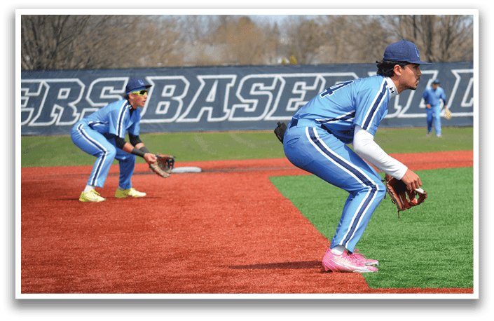 Two baseball players in blue uniforms are on the field, one of them is crouching down and holding a baseball glove. AI generated content