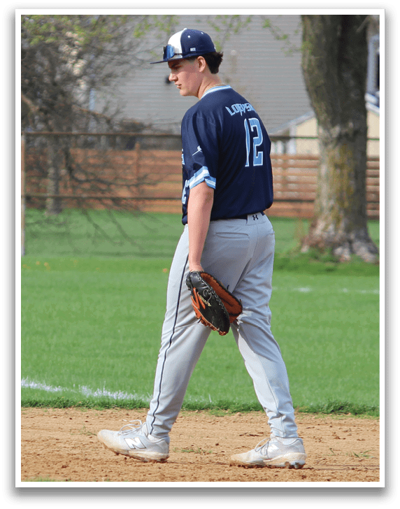 A baseball player in a blue shirt and gray pants is standing on a baseball field. AI generated content