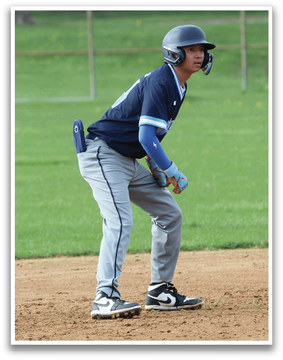 A baseball player in a blue shirt and gray pants is standing on the field, holding a bat and preparing to swing. AI generated content