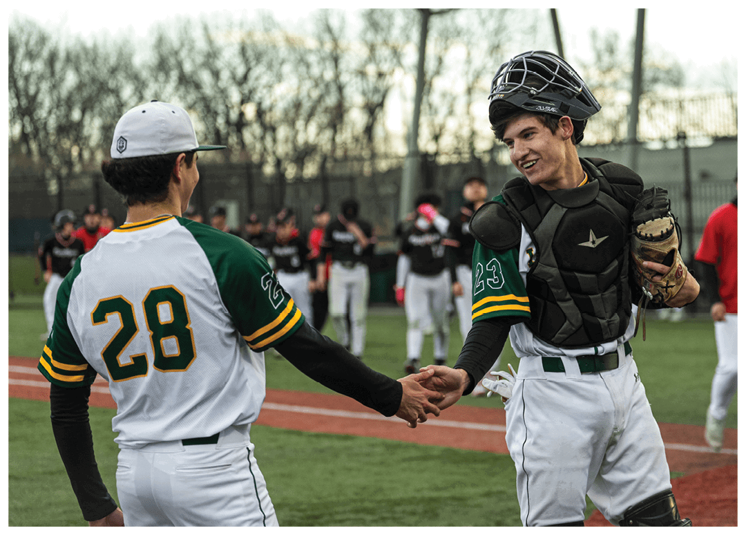 Two baseball players shake hands on the field. Description generated by AI