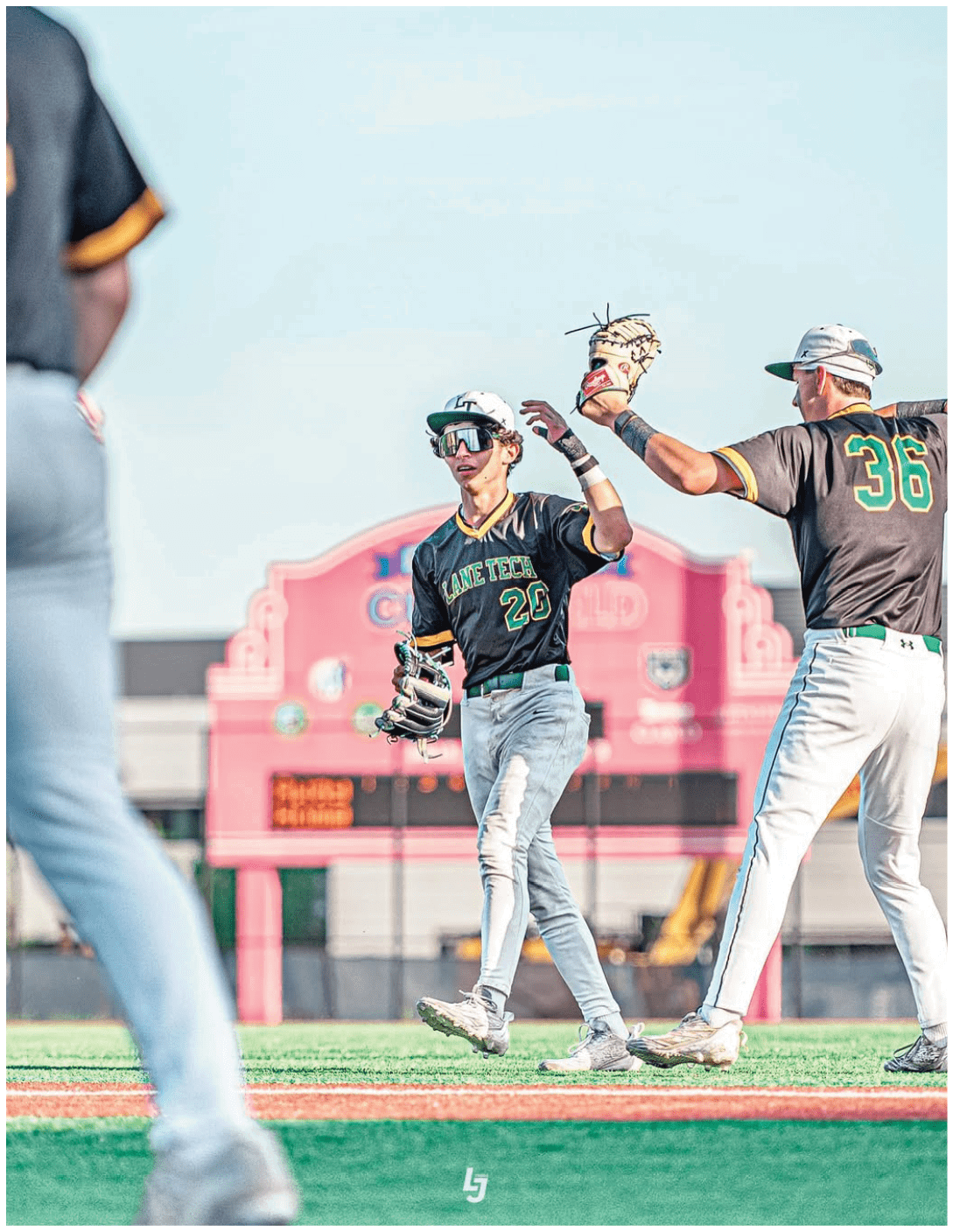 A baseball player wearing a black and yellow jersey. Description generated by AI