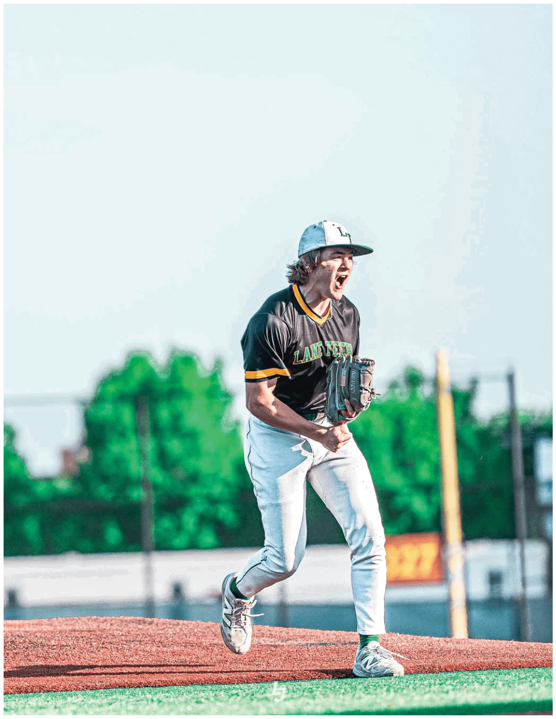A baseball player with a black shirt and yellow letters on it. Description generated by AI