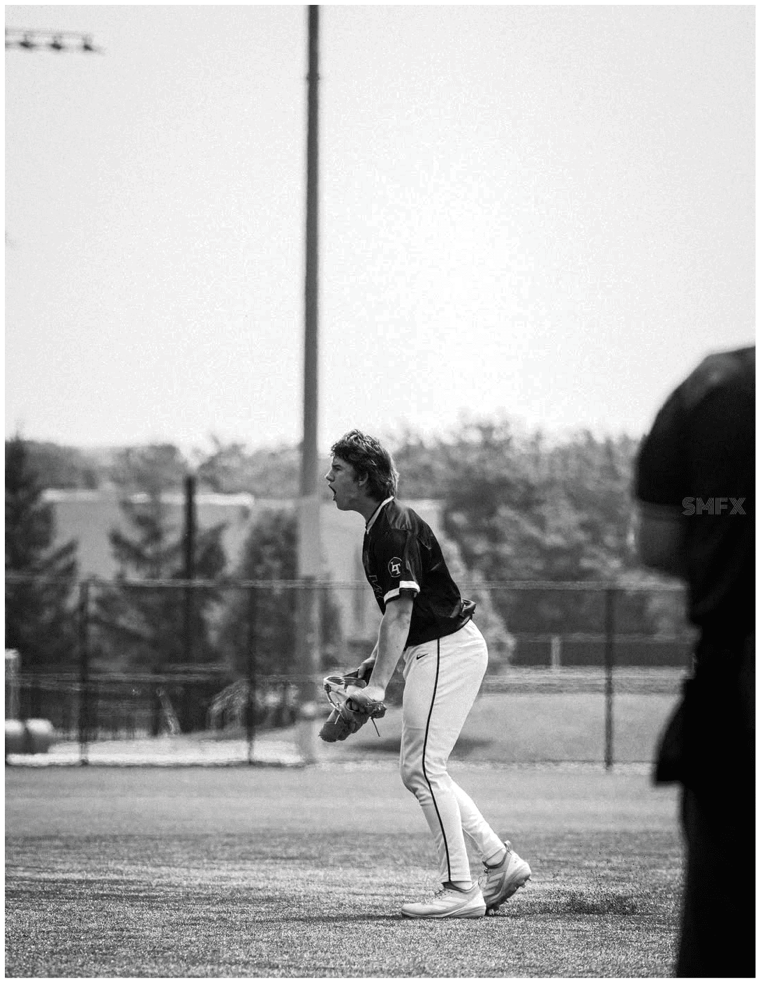 A baseball player wearing a green helmet and white pants. Description generated by AI