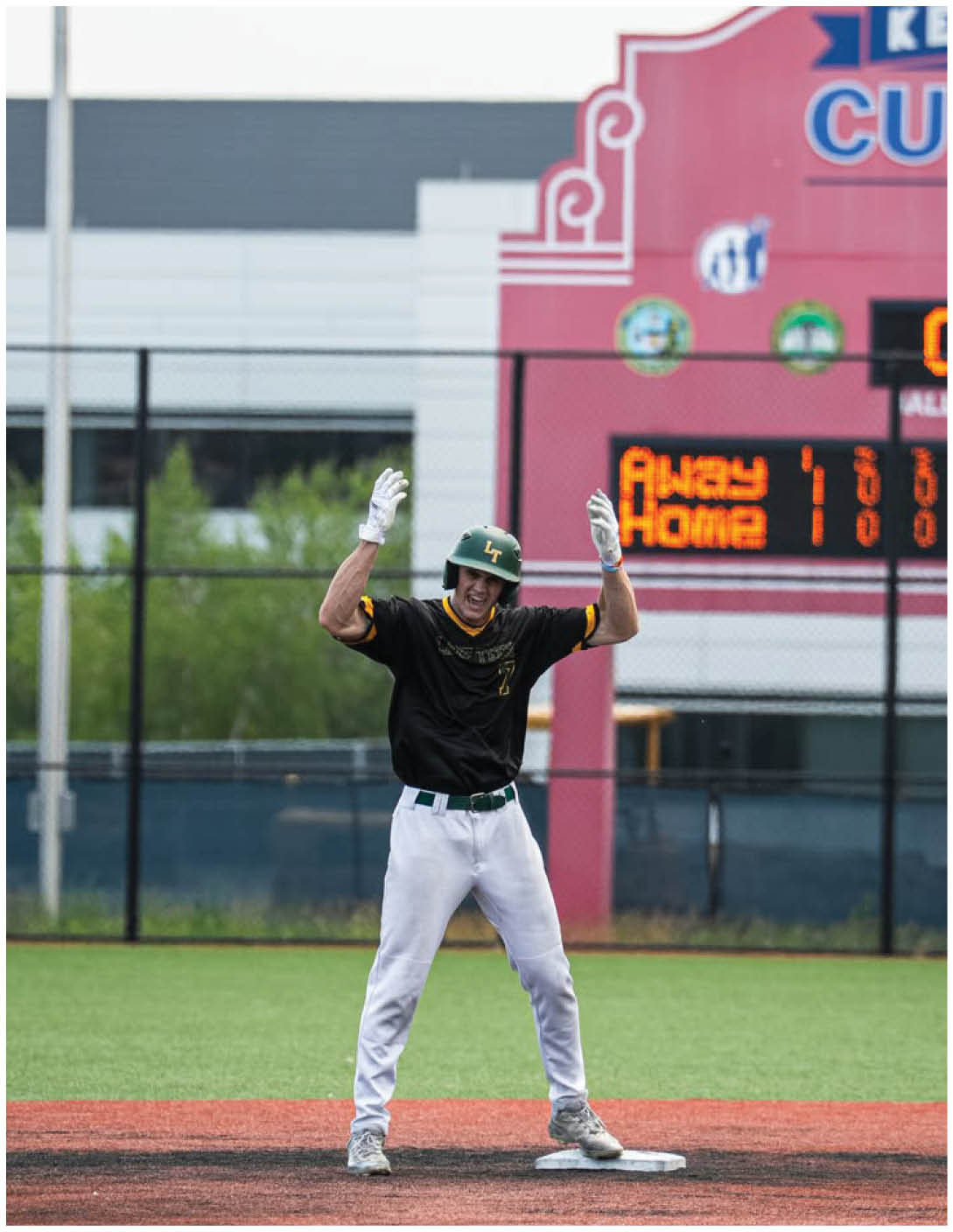 A baseball player wearing a black and yellow jersey. Description generated by AI