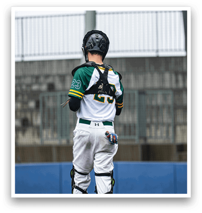 A baseball player in a white and green uniform stands on the field, holding a bat. AI generated content