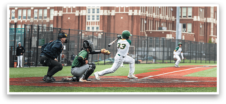 A baseball game is taking place with a batter swinging a bat at a ball. The batter is wearing a green shirt and a white helmet. A catcher is positioned behind the batter, ready to catch the ball. There are several other players on the field, including one holding a baseball glove. The scene is set in front of a large building, possibly a stadium. AI generated content