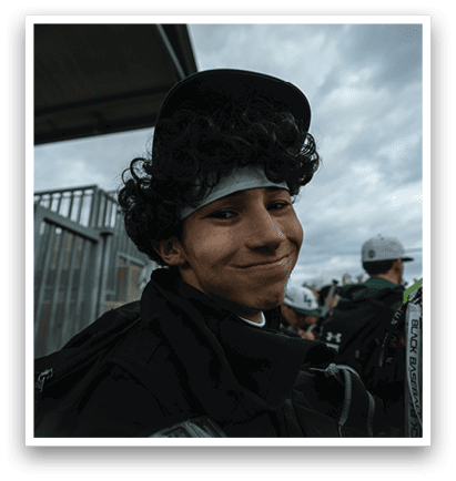 A young man wearing a black hat and a white headband is smiling. AI generated content