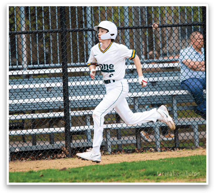 A baseball player in a white uniform is running towards home plate. AI generated content