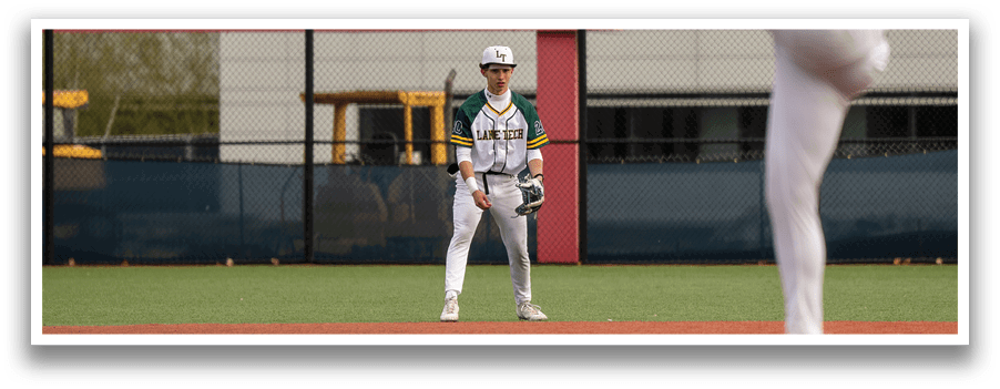 A baseball player in a white uniform is pitching a ball on a field. AI generated content