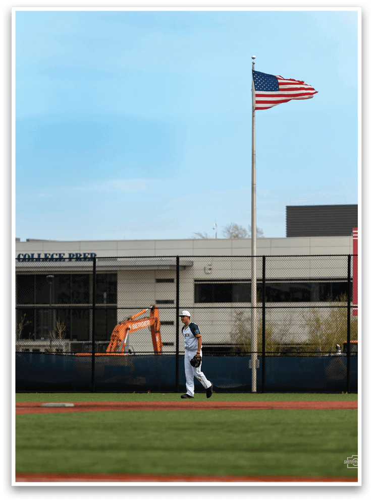 A man is walking on a baseball field, carrying a baseball bat. AI generated content