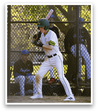 A baseball player in a green helmet and white uniform is holding a bat and getting ready to swing. Description generated by AI