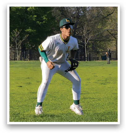A baseball player in a white uniform and green sleeves is standing on a field. Description generated by AI