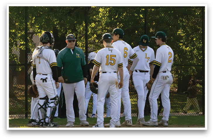 A group of baseball players wearing white uniforms. Description generated by AI