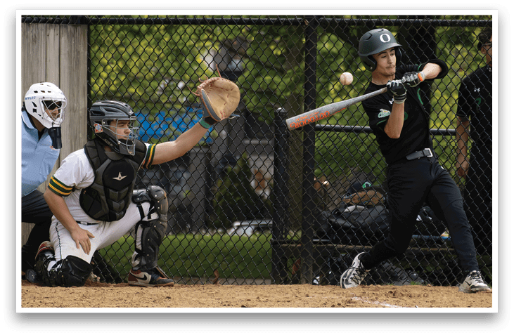 A baseball player is swinging a bat at a ball. Description generated by AI