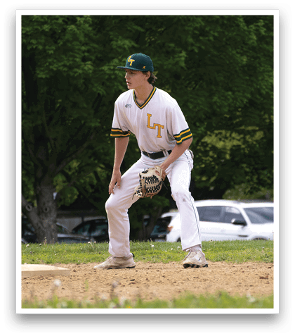 A baseball player is standing on the field with his glove on. Description generated by AI
