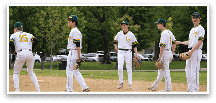 Baseball players standing on a field. Description generated by AI