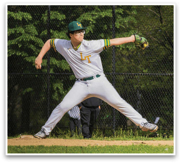 A baseball player in a white uniform is pitching a ball. Description generated by AI