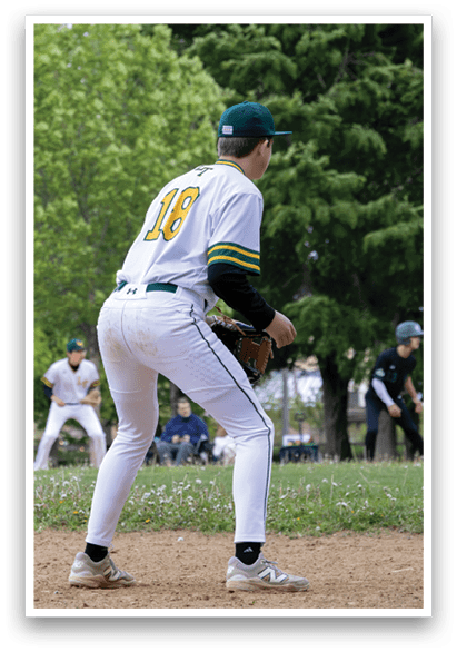 A baseball player in a white uniform with the number 18 on the back. Description generated by AI