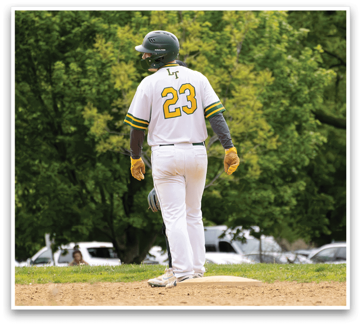 A baseball player wearing a white and green jersey with the number 23 on it. Description generated by AI