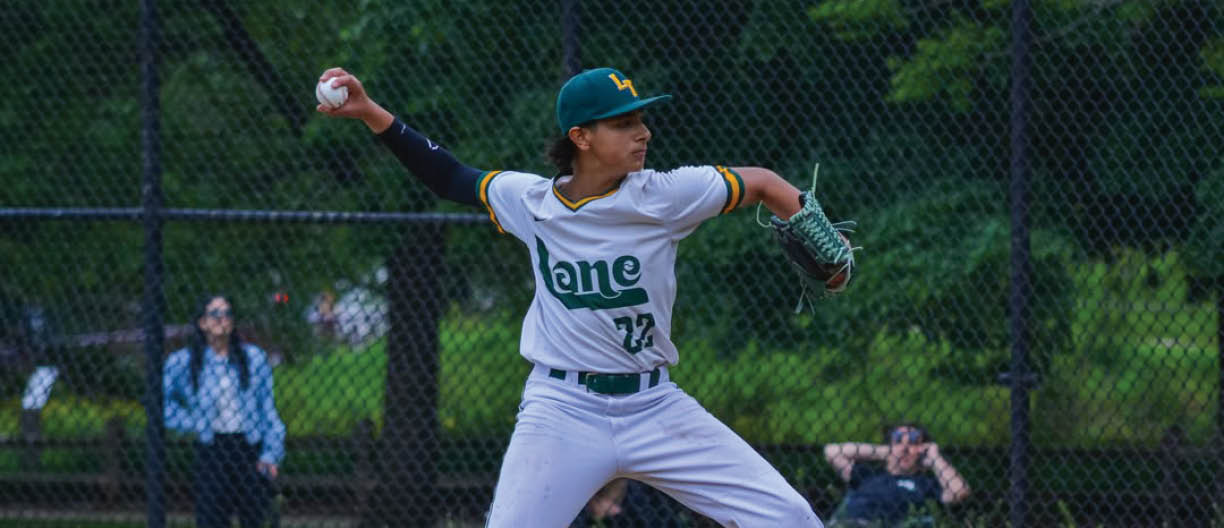 A baseball player in a white uniform is pitching a ball. Description generated by AI