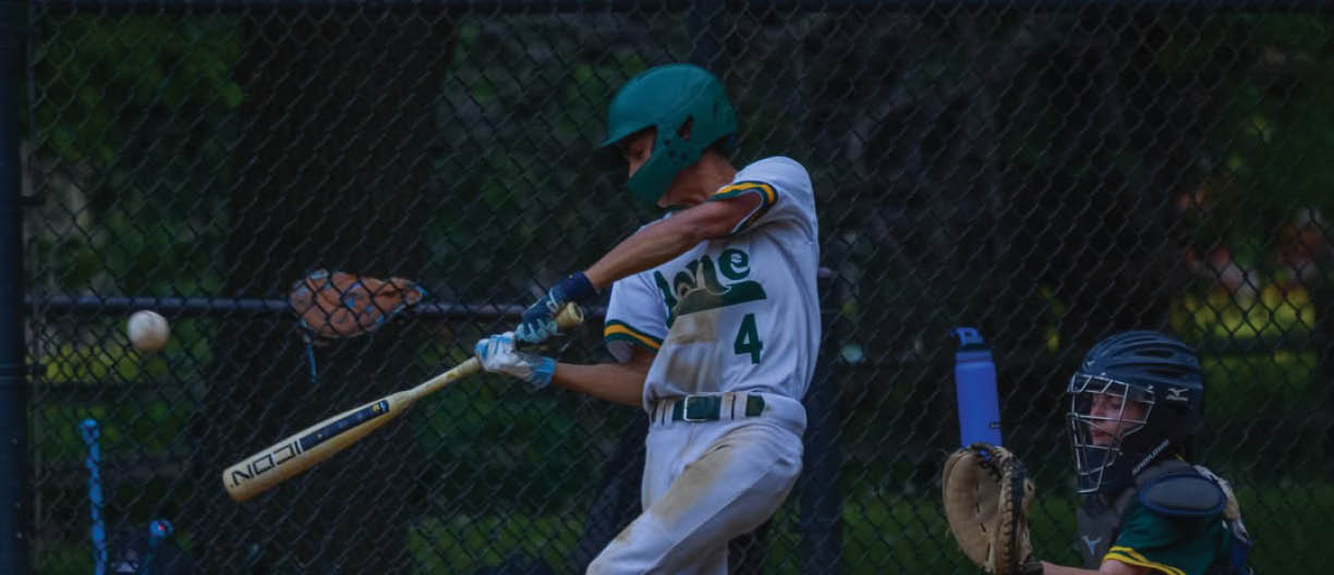 A baseball player is swinging a bat at a ball. Description generated by AI