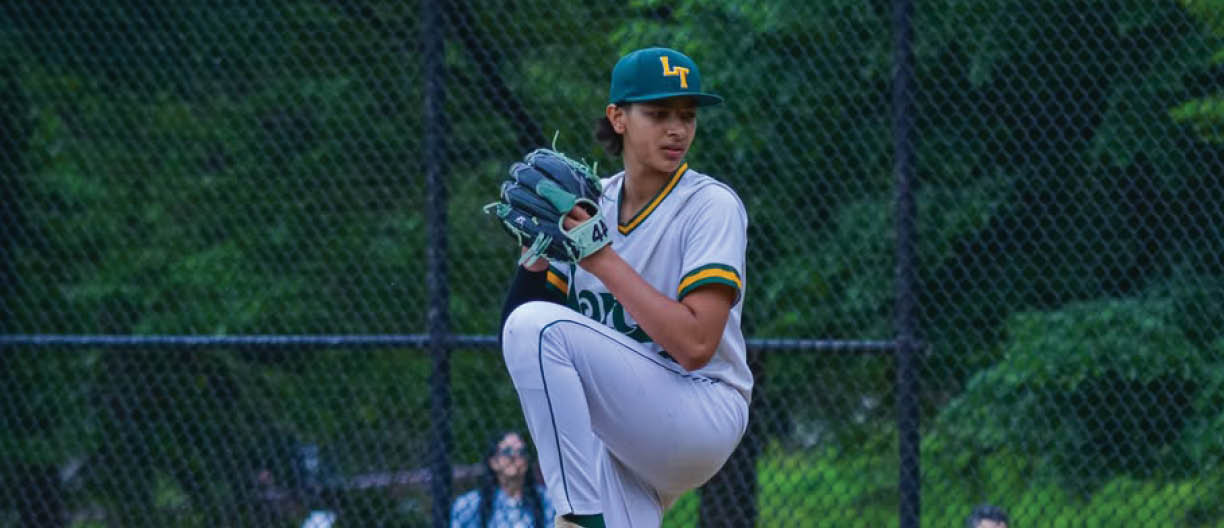 A baseball player in a white uniform is pitching a ball. Description generated by AI