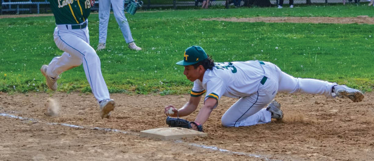 A baseball player sliding into a base. Description generated by AI