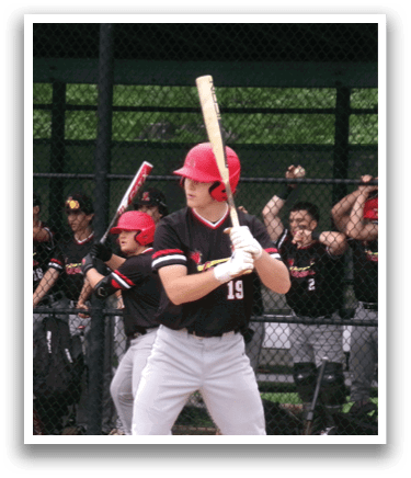 A baseball player in a red helmet and black jersey is holding a bat, ready to swing. AI generated content