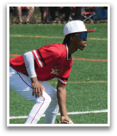 A baseball player in a red shirt and white pants is crouching down on the field, wearing a baseball glove. AI generated content