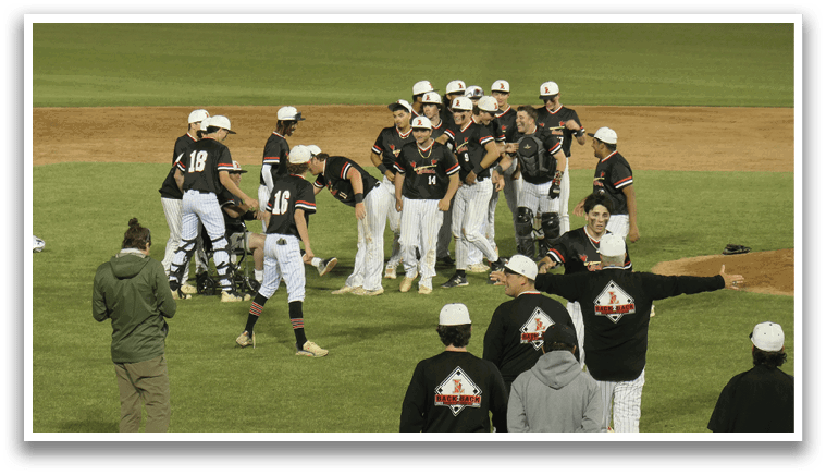 A group of baseball players are standing on a field, some of them wearing black and white uniforms. They are gathered around a man who is holding a baseball bat. AI generated content