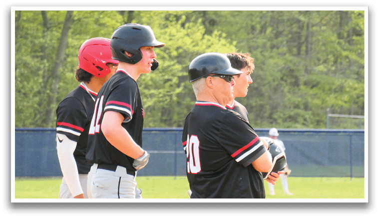 Three baseball players wearing black and red uniforms are standing on a field. AI generated content
